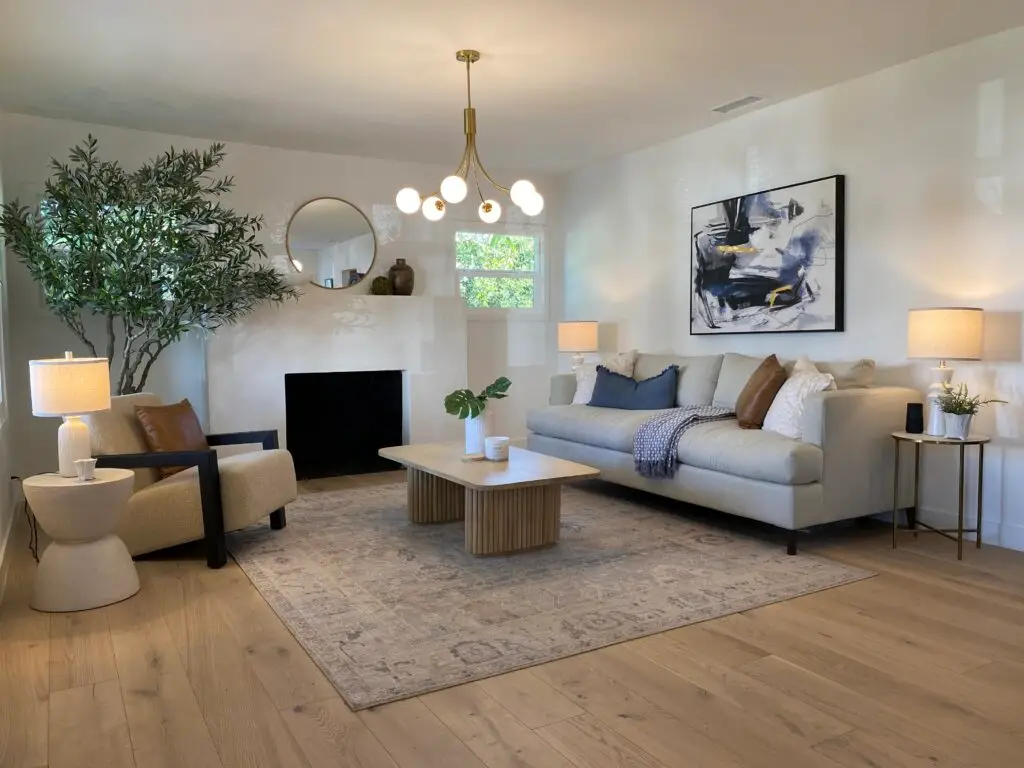 Remodeled living room inside 1108 E Harvard Glendale Craftsman Home with natural light, fireplace, and updated flooring.