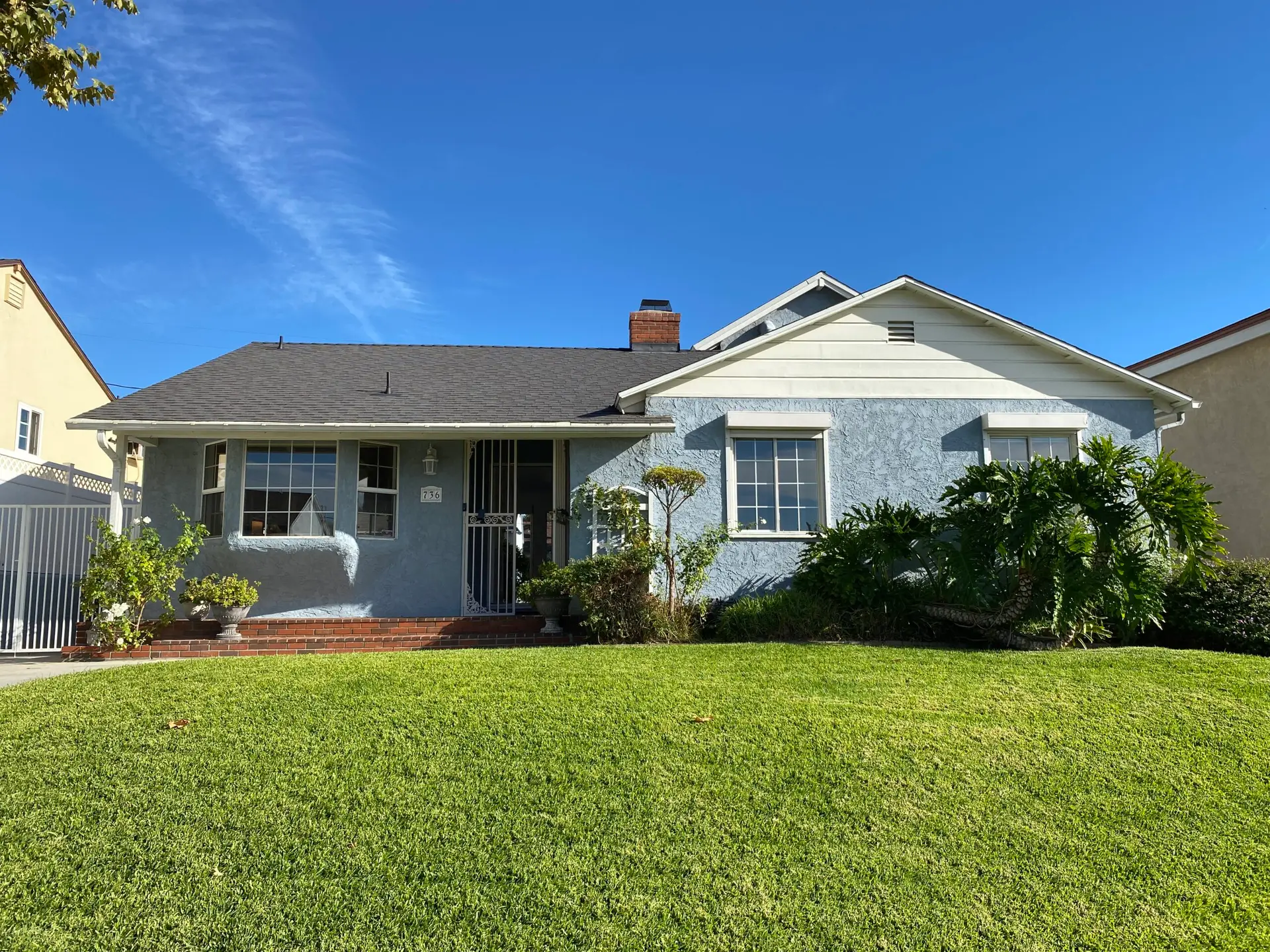 Front exterior of 736 Irving Drive Burbank Ranch Home with mature trees and classic single-story design.