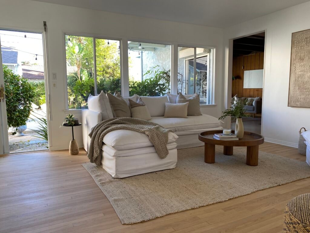 Living room at 736 Irving Drive Burbank Ranch Home featuring stone fireplace, wood floors, and natural light.