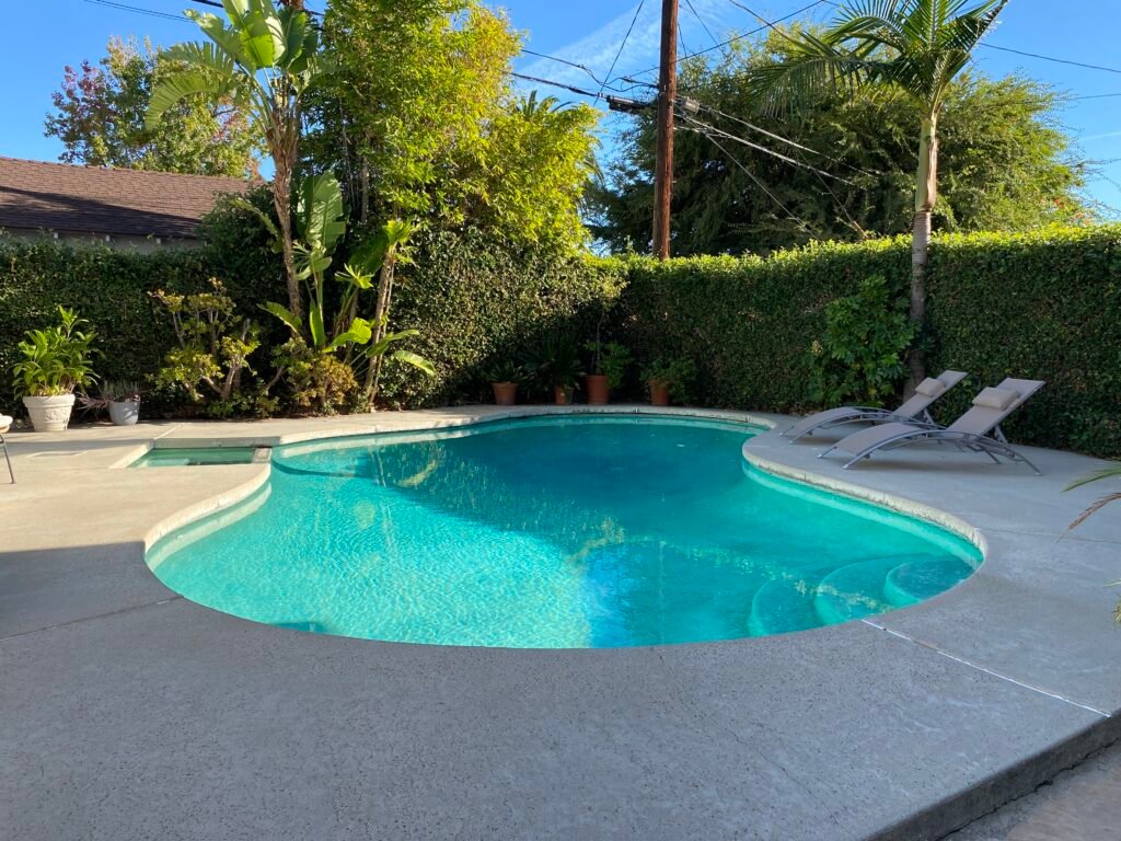 Pool area at 736 Irving Drive Burbank Ranch Home with privacy hedges and hillside setting.